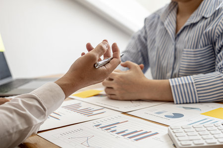 Finance staff are presenting financial information to finance managers by documenting charts, providing financial information to plan and develop the company's finances to grow. Financial concept.の写真素材