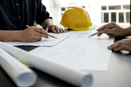 Architects and engineers are working together to edit the draft house plan that was designed after it was presented to the client and partially revised the design. Interior design and decoration ideasの写真素材