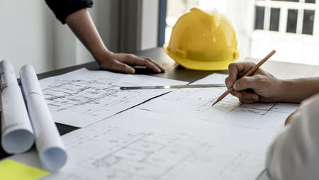 The architects and engineers were in a meeting to discuss the draft house plan designed after it was presented to the client. A partial design revision was requested. Interior design and decoration ideas.の写真素材