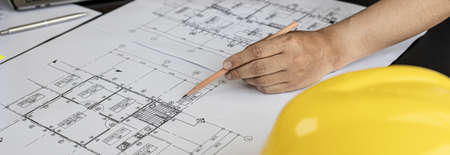 Close-up, the architect is solving the house plan he designed after it was presented to the client and asked to modify the design. Interior design and decoration ideas.の写真素材