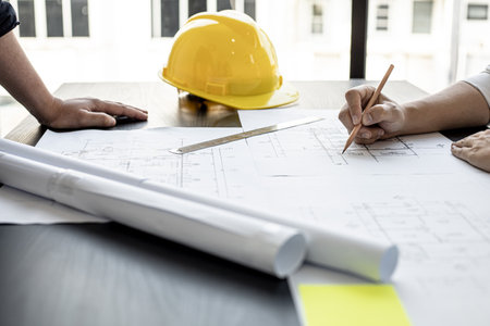 The architects and engineers were in a meeting to discuss the draft house plan designed after it was presented to the client. A partial design revision was requested. Interior design and decoration ideas.の写真素材
