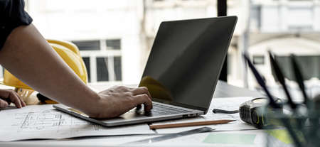 Professional home designers architects are reviewing the laptop house designs sketched in the program. Interior design and decoration ideas.の写真素材