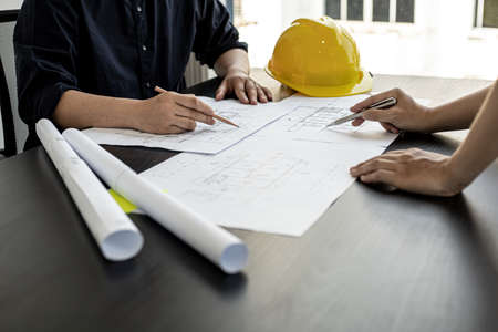 Architects and engineers are working together to edit the draft house plan that was designed after it was presented to the client and partially revised the design. Interior design and decoration ideasの写真素材