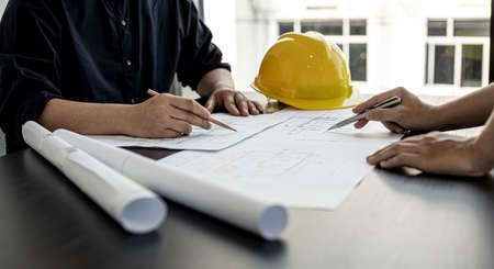 Architects and engineers are working together to edit the draft house plan that was designed after it was presented to the client and partially revised the design. Interior design and decoration ideasの写真素材