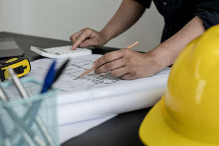 The home design architects are reviewing the house plan draft, the project commissioned by the client, and the custom design before delivery. Interior design and decoration ideas.の写真素材