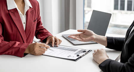The job applicant is attending a job interview with the department manager and is introducing himself and explaining the information in the resume to the manager in order to be elected to the company.の写真素材