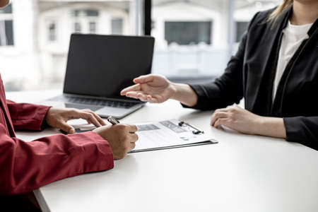 The job applicant is attending a job interview with the department manager and is introducing himself and explaining the information in the resume to the manager in order to be elected to the company.の写真素材