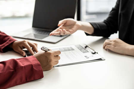 The job applicant is attending a job interview with the department manager and is introducing himself and explaining the information in the resume to the manager in order to be elected to the company.の写真素材