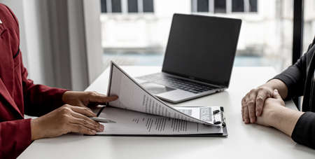 Recruiting people to work in the company vacancies, recruiting employees to work in the vacancy, qualifying by job position and interviewing by department manager. The manager is reviewing the resume.の写真素材