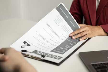 Recruiting people to work in the company vacancies, recruiting employees to work in the vacancy, qualifying by job position and interviewing by department manager. The manager is reviewing the resume.の写真素材