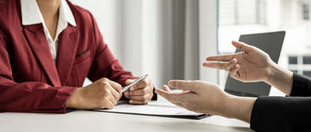 The job applicant is attending a job interview with the department manager and is introducing himself and explaining the information in the resume to the manager in order to be elected to the company.の写真素材