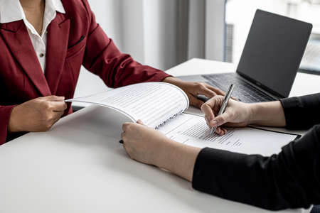 The job applicant is checking the resume with the Human Resources Department before taking the job interview with the department manager who has submitted the application. Job application ideas.の写真素材