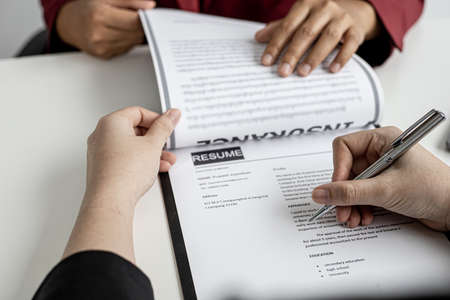 The job applicant is checking the resume with the Human Resources Department before taking the job interview with the department manager who has submitted the application. Job application ideas.の写真素材