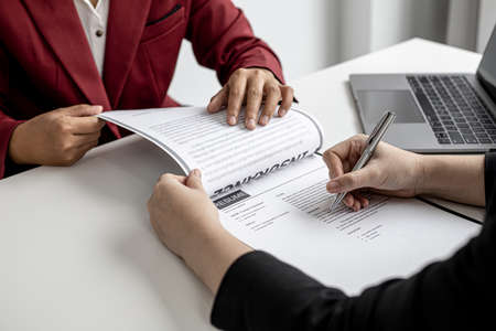 The job applicant is checking the resume with the Human Resources Department before taking the job interview with the department manager who has submitted the application. Job application ideas.の写真素材