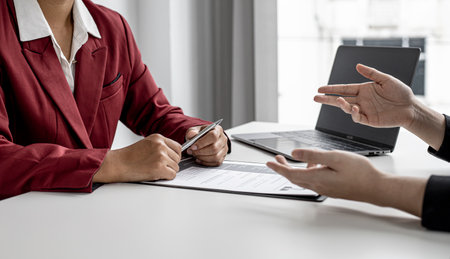 The job applicant is attending a job interview with the department manager and is introducing himself and explaining the information in the resume to the manager in order to be elected to the company.の写真素材