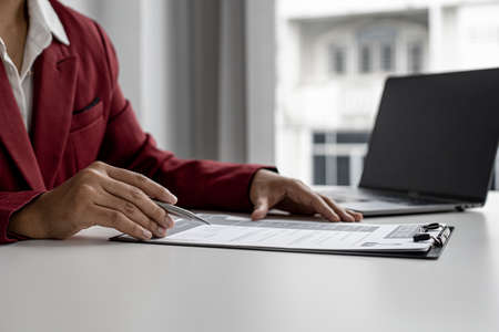 Recruiting people to work in the company vacancies, recruiting employees to work in the vacancy, qualifying by job position and interviewing by department manager. The manager is reviewing the resume.の写真素材