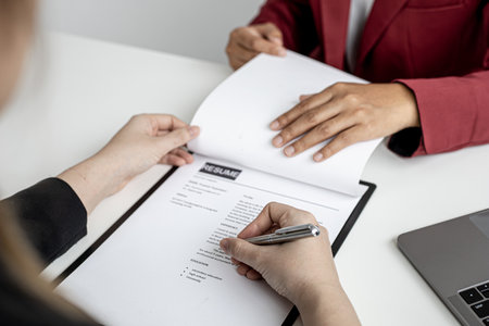 The job applicant is checking the resume with the Human Resources Department before taking the job interview with the department manager who has submitted the application. Job application ideas.の写真素材
