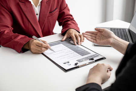 The job applicant is attending a job interview with the department manager and is introducing himself and explaining the information in the resume to the manager in order to be elected to the company.の写真素材