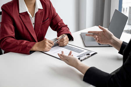 The job applicant is attending a job interview with the department manager and is introducing himself and explaining the information in the resume to the manager in order to be elected to the company.の写真素材