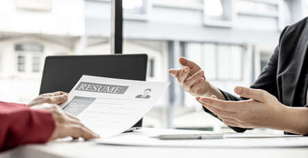 The job applicant is attending a job interview with the department manager and is introducing himself and explaining the information in the resume to the manager in order to be elected to the company.の写真素材