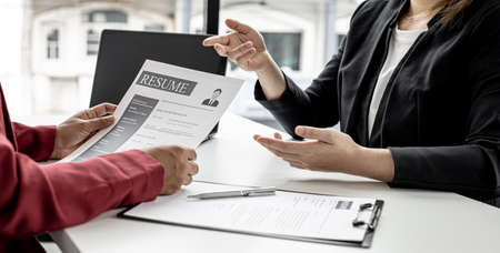 The job applicant is attending a job interview with the department manager and is introducing himself and explaining the information in the resume to the manager in order to be elected to the company.の写真素材