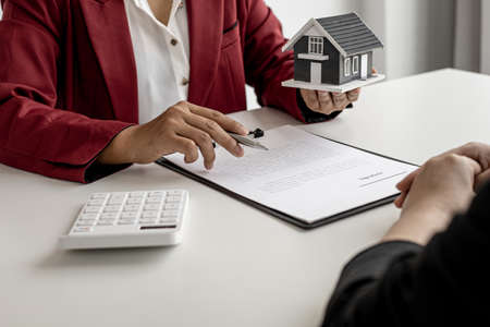 The landlord is describing the home and the rental agreement to the tenant before agreeing to sign the lease after taking the tenant's visit to the home. Real estate rental ideas.の写真素材