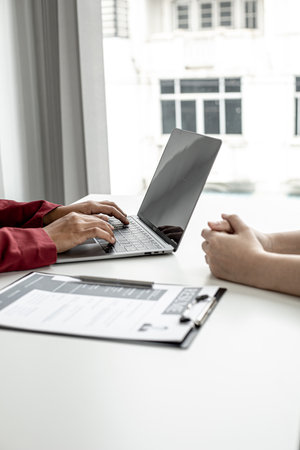 The HR department is typing a laptop to fill out the applicant's information after being interviewed by the department manager and accepting jobs for the job applicant. Job application ideas.の写真素材