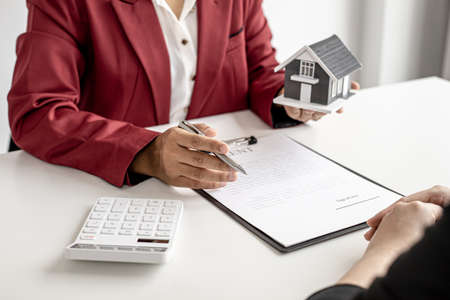 The landlord is describing the home and the rental agreement to the tenant before agreeing to sign the lease after taking the tenant's visit to the home. Real estate rental ideas.の写真素材