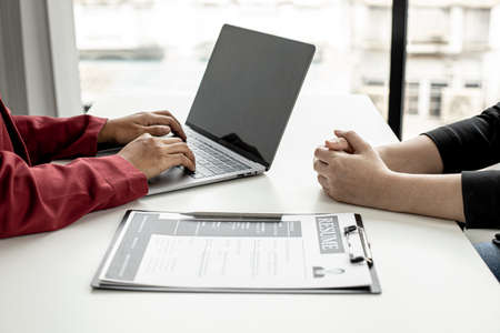The HR department is typing a laptop to fill out the applicant's information after being interviewed by the department manager and accepting jobs for the job applicant. Job application ideas.の写真素材