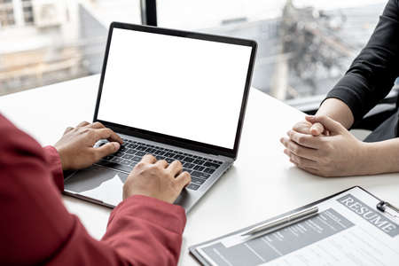 The HR department is typing a laptop to fill out the applicant's information after being interviewed by the department manager and accepting jobs for the job applicant. Job application ideas.の写真素材