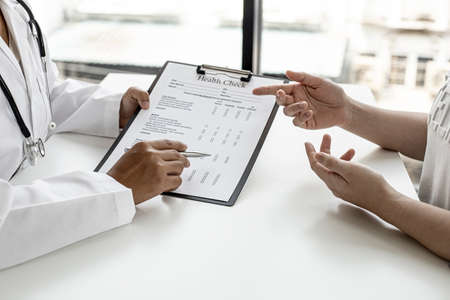 The doctor and the patient are discussing the details of the treatment, the results of the physical examination of the patient. Annual physical examination concept.の写真素材