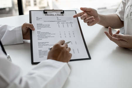 The doctor and the patient are discussing the details of the treatment, the results of the physical examination of the patient. Annual physical examination concept.の写真素材