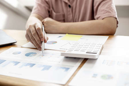 Finance employees are reviewing the financial information on documents that were prepared before sending them to management for a meeting with shareholders. Financial concept.の写真素材