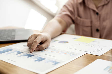 Finance employees are reviewing the financial information on documents that were prepared before sending them to management for a meeting with shareholders. Financial concept.の写真素材