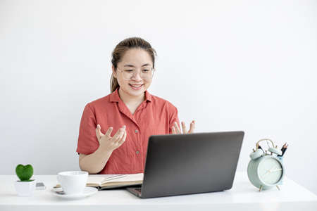 The businesswoman is on a teleconference with her partner and secretary, the company
