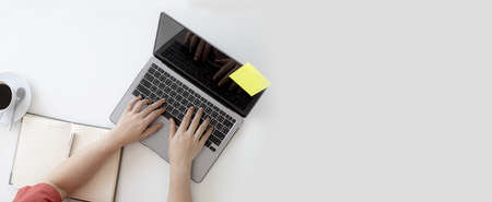 Top view of a business woman's desk using a laptop to communicate with a partner to chat, on the...