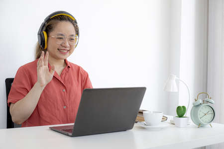 The businesswoman is on a teleconference with her partner and secretary, the company announces that employees work from home to prevent the spread of COVID-19. The idea of working from home.の写真素材