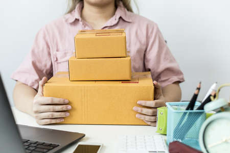 The staff pack of the preparation of the pack is finished, deliver to the customer according to the order list through the private transport company. Online sales concepts and shipping.の写真素材