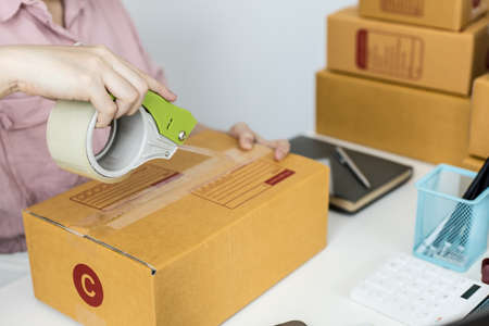 Employees are packing products according to orders from customers on the online website. And forward to the private transport company to continue to deliver products in reaching customers.の写真素材