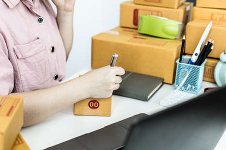 Employees are writing customer shipments to order products through online websites and deliver...