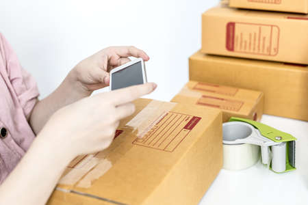 The admin page of the online sales site is taking a picture of the front of the package containing...