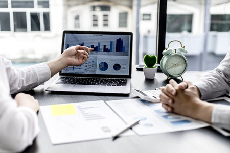 Businesswomen are opening up their laptop's financial information for business partnerships, they are planning to manage their finances and solve common problems. Concept of business administration.の写真素材