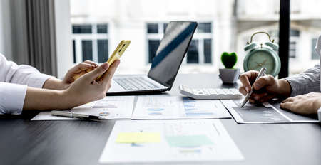 Two businessmen are talking in their office, meeting a marketing plan for solving the problem of...