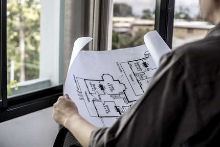 Architect engineers are writing house plans in order to modify some of the designs