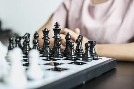 A chess board game with white and black chess piecesの写真素材