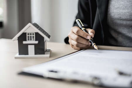 The salesperson is checking the contract before making an appointment for the customer to join the...