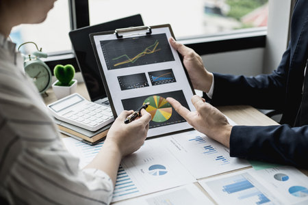The head of the finance department presents the financial information to the executives, the company's financial data for the past month for analysis and planning for the next month.の写真素材