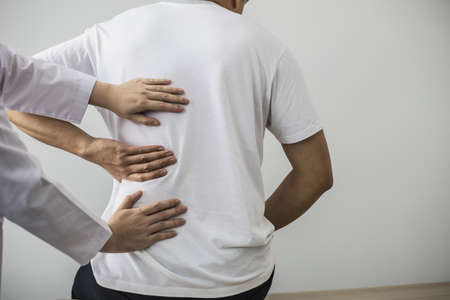 Professional physiotherapists are working to relax the muscles for patients who are treated for muscle disorders, most patients are office workers who sit for a long time causing pain. office syndromeの写真素材