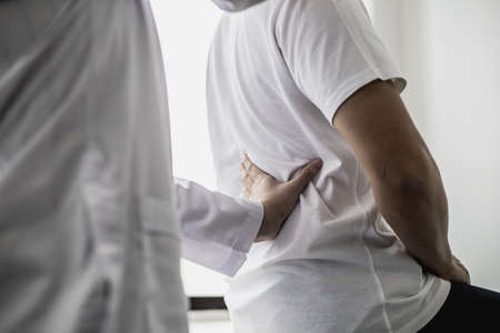 Professional physiotherapists are working to relax the muscles for patients who are treated for muscle disorders, most patients are office workers who sit for a long time causing pain. office syndromeの写真素材