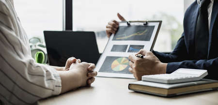 Two businessmen are meeting together on the topic of monthly finance, financial documents prepared by the finance department. Concept of financial management according to company policy.の写真素材
